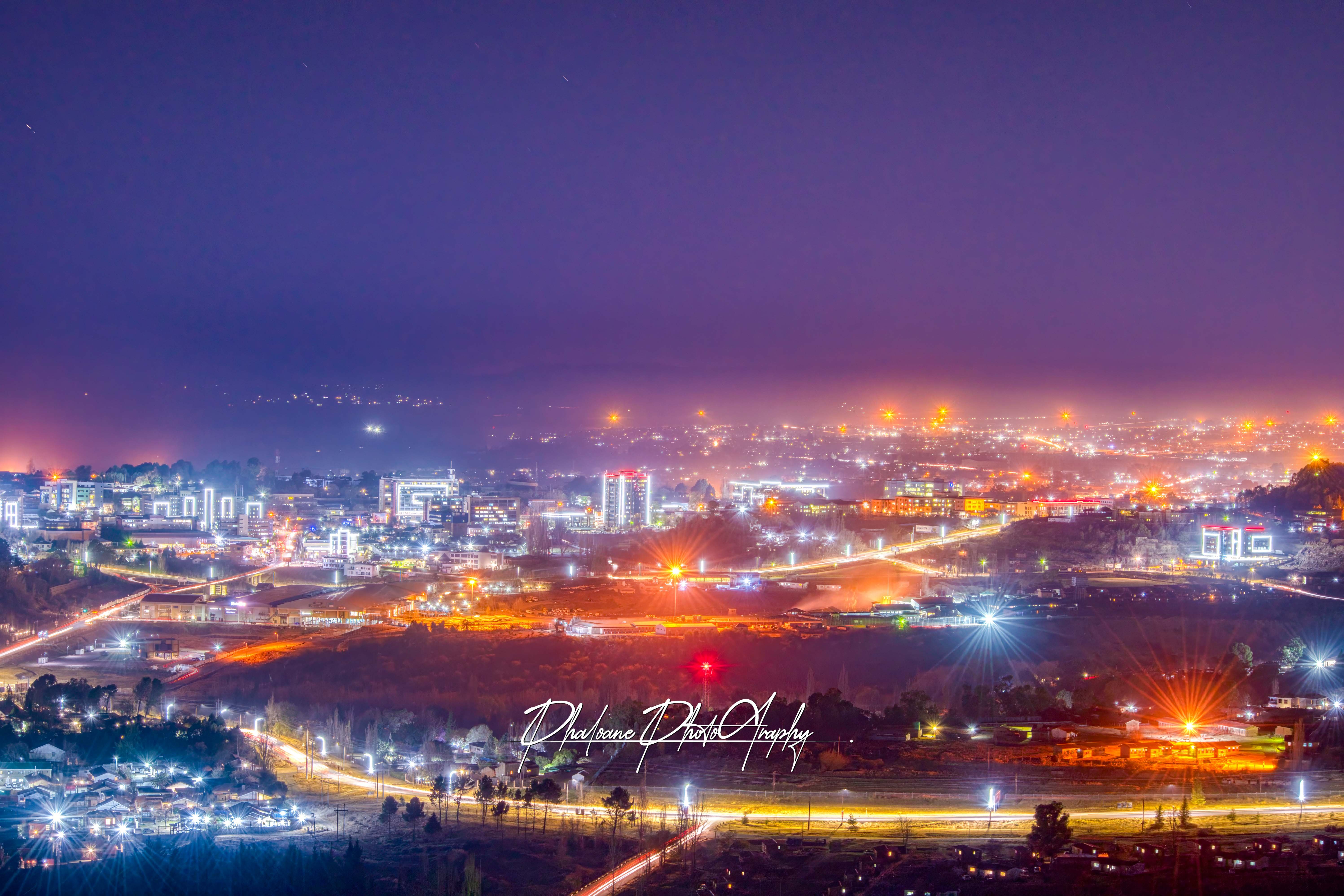 The city of Maseru at night with vibrant lights and many cars